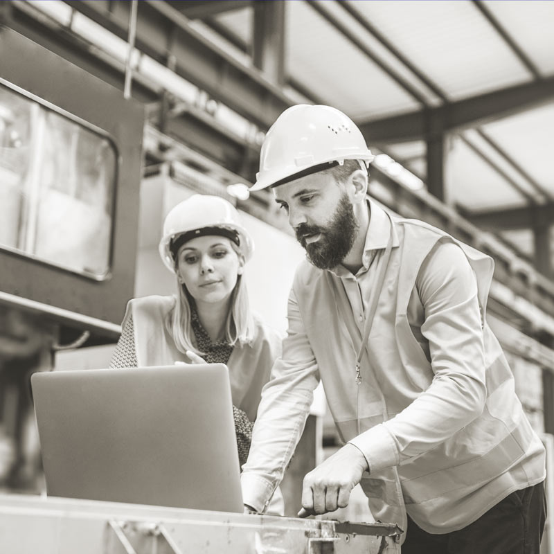 man and woman working on laptop